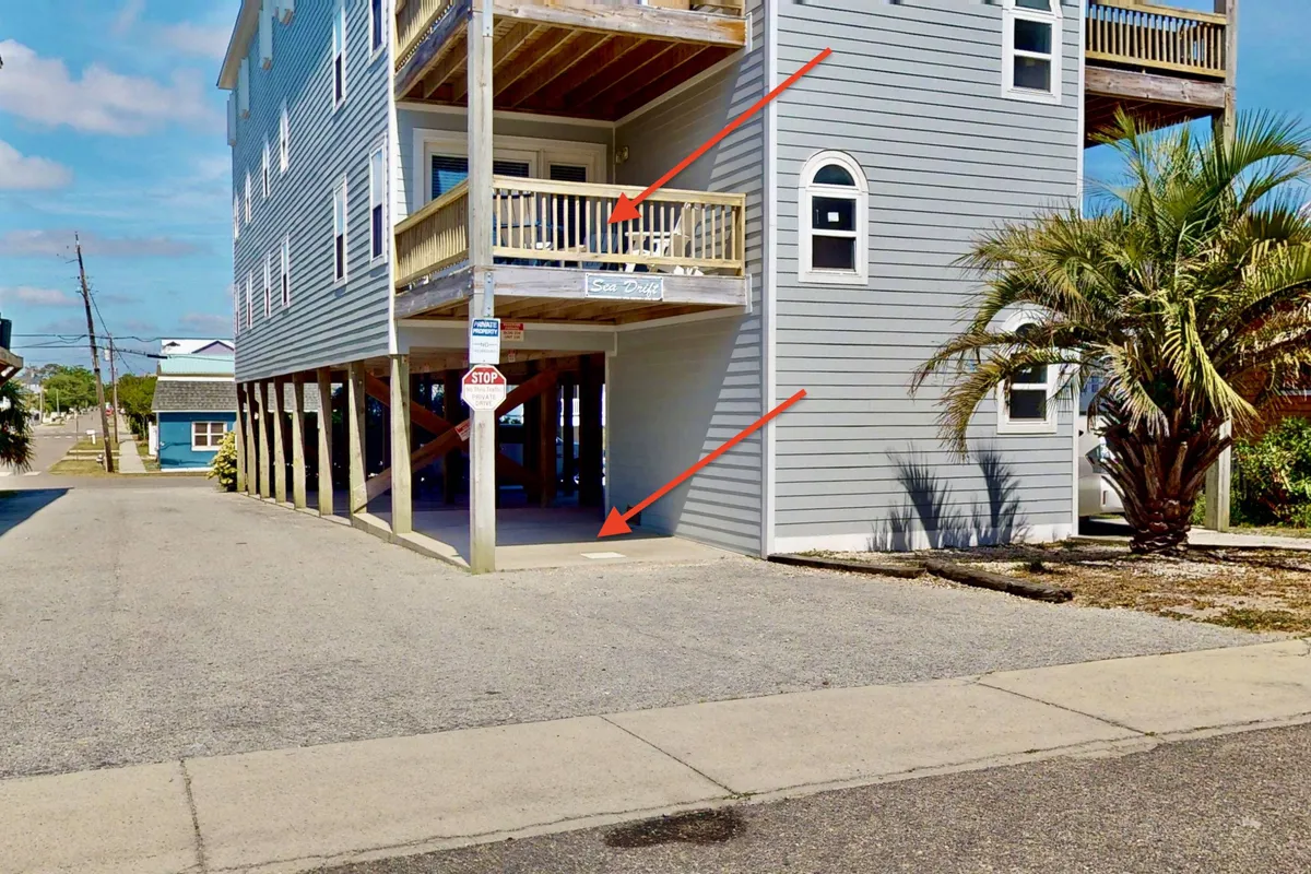 An exterior view showing a balcony with a palm tree and foundation pillars, offering a casual, laid-back outdoor space. The setting suggests a relaxing return home after a day of exploration, with opportunities for morning coffee or sunset views.